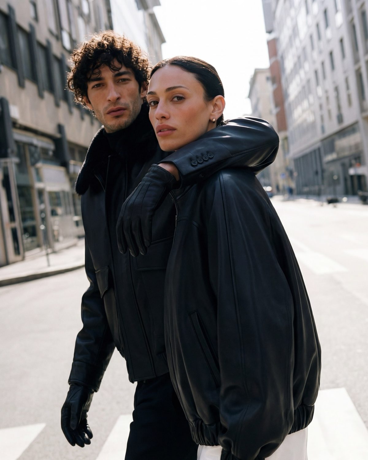 Source reference for AI product photography — two models in leather outerwear, urban e-commerce editorial